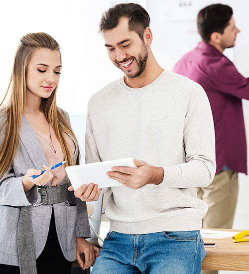 two people looking at a tablet