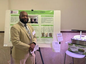 research presenter next to research poster